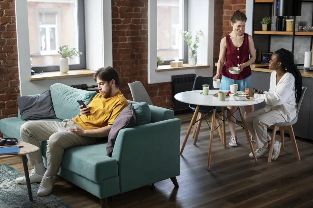 Residents working and talking in a shared Marrakech living space