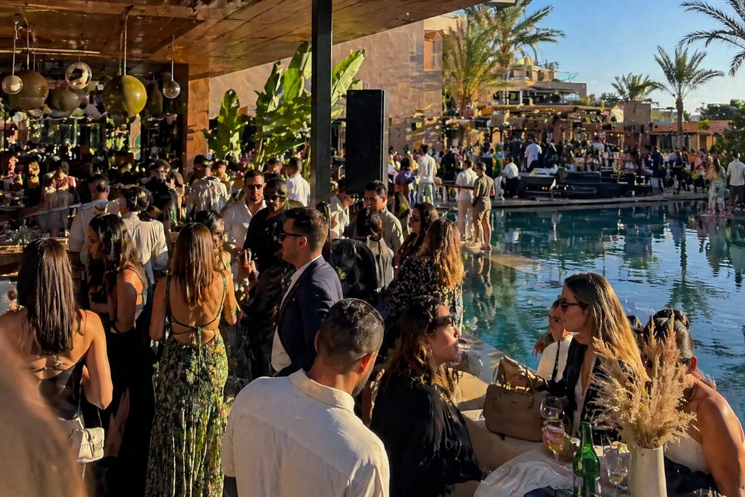 Guests gathered around a busy outdoor pool