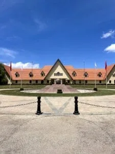 Symmetrical Al Akhawayn University building with red-tiled roofs beneath a clear blue sky