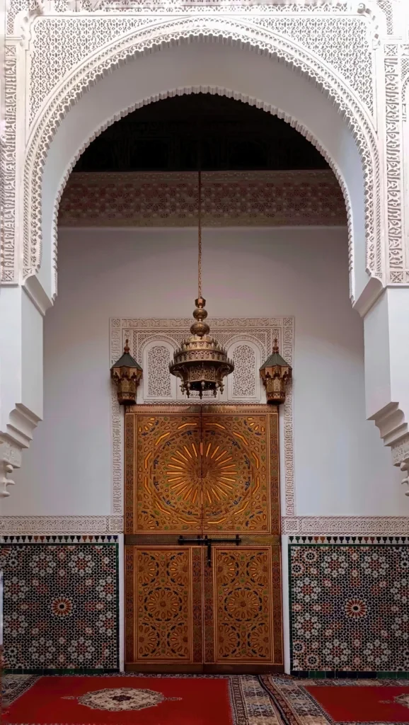 Moroccan artisan shaping zellige tiles inside a luxury home
