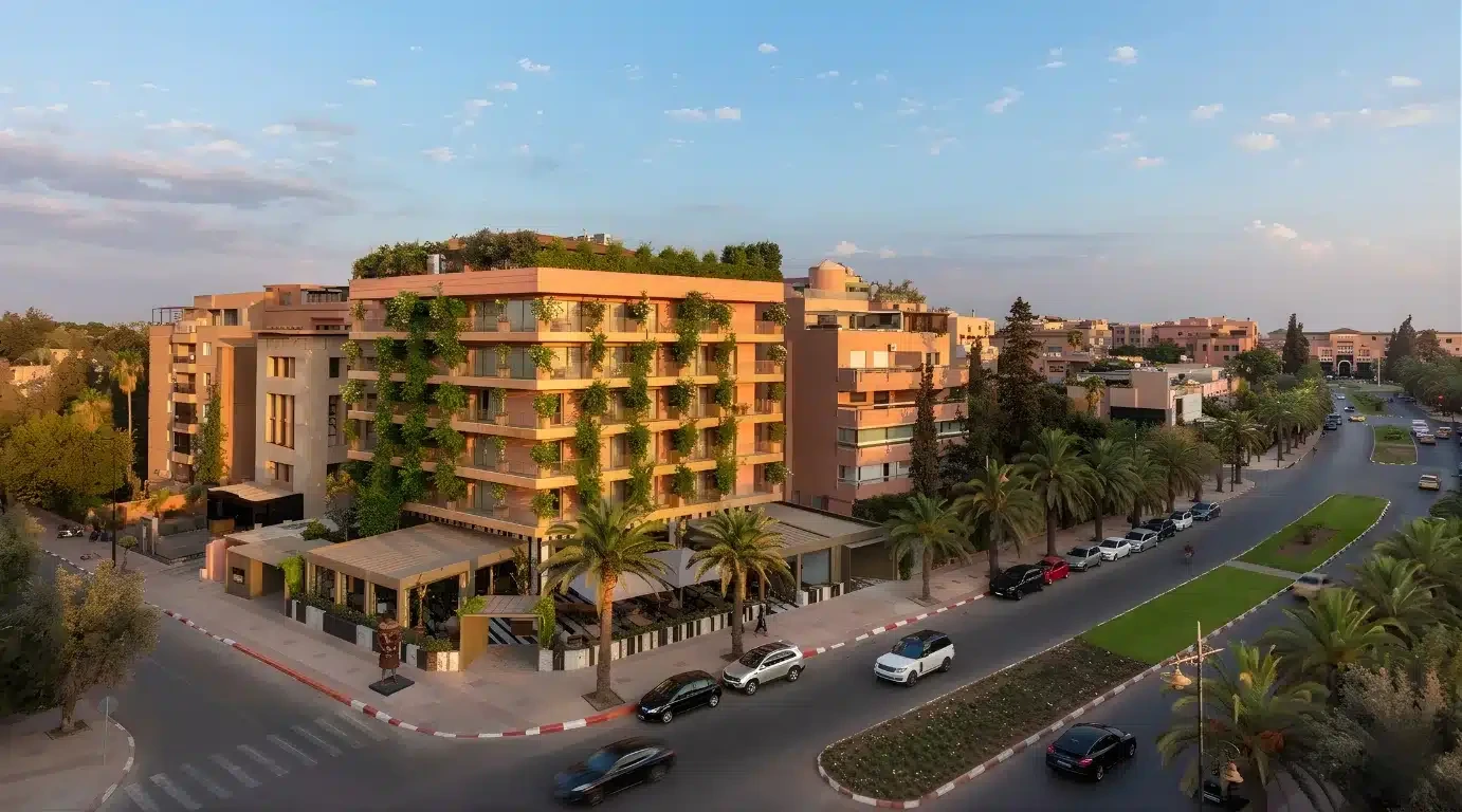 Modern apartment buildings along a landscaped Marrakech avenue