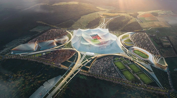Aerial rendering of a large stadium complex and surrounding development