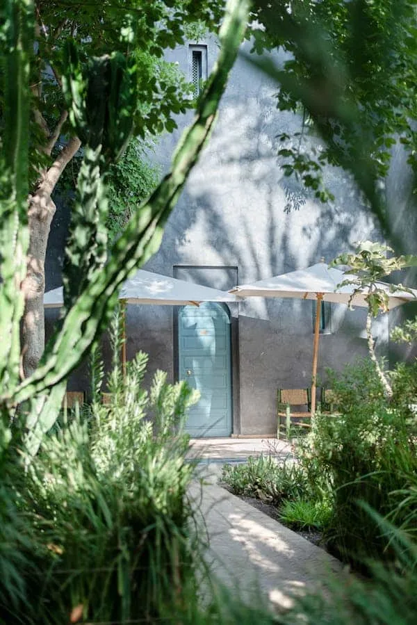 A shaded swimming pool and garden in Marrakech during summer