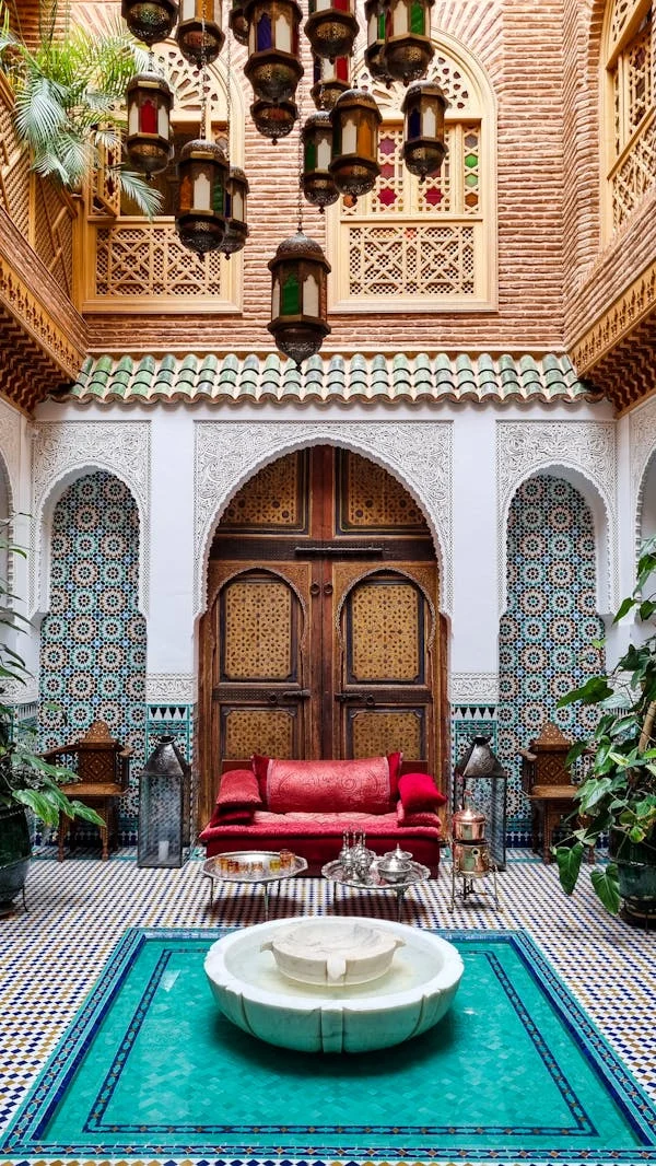 Restored Moroccan riad courtyard with zellige and planted garden