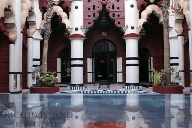 Courtyard of Ziwana Palace historical palace riad Marrakech with fountain and mosaic tiles