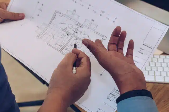 Architects discussing floor plans of an off-plan property in Marrakech.