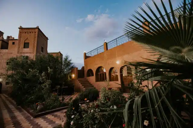 A comparison between renovation vs new villas in Marrakech, showing an old villa being restored alongside a newly built modern villa.