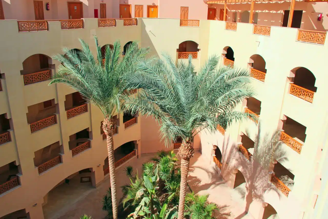 Marrakech second home trend with palm trees and courtyard-style residential building