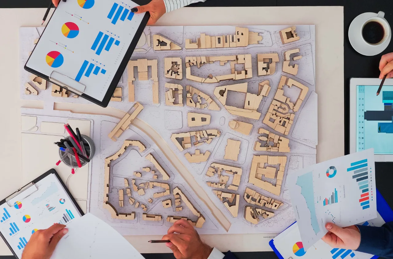 Business professionals planning and discussing strategies, illustrating a beginner's guide to real estate investing.