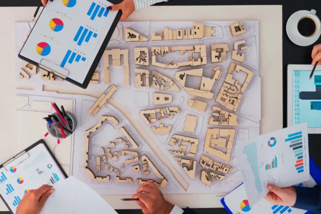 Business professionals planning and discussing strategies, illustrating a beginner's guide to real estate investing.