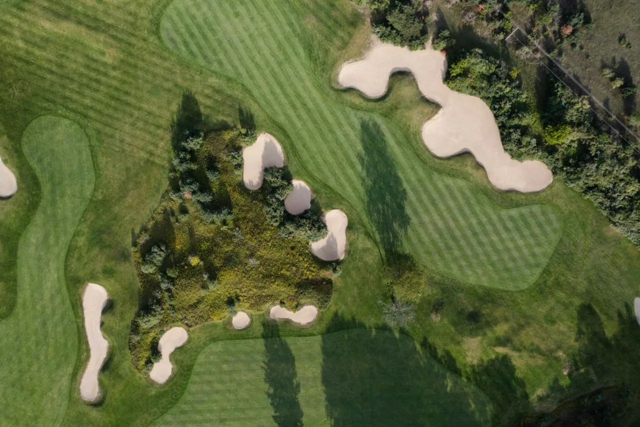 Aerial view of lush golf course fairways and sand bunkers in Marrakech luxury golf communities