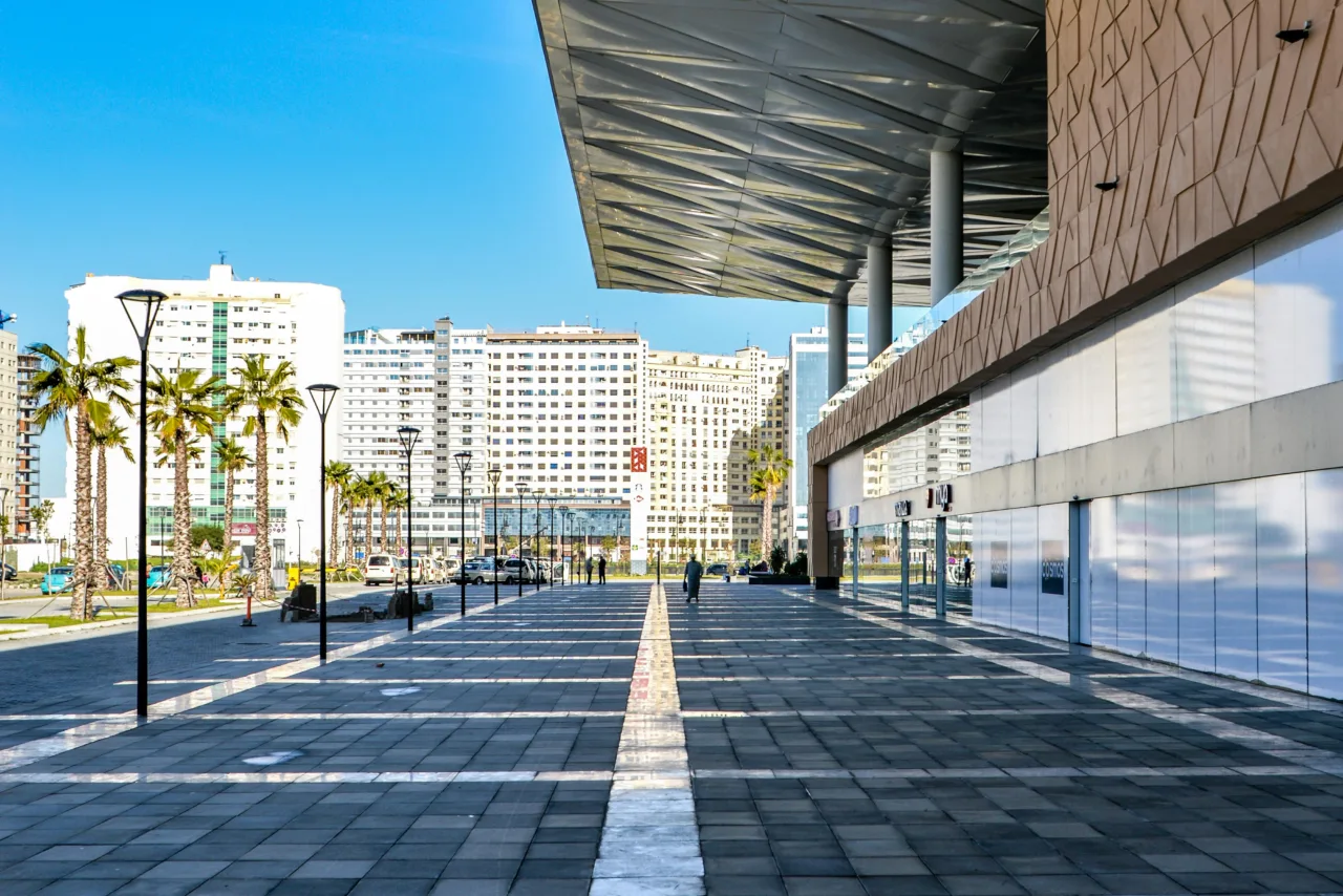 Modern urban infrastructure near a transport hub in Morocco, representing transit oriented development Morocco with mixed-use buildings and pedestrian pathways.
